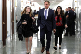 Sen. Jeff Flake, R-Ariz., arrives for the Senate Judiciary hearing on Capitol Hill in Washington, Thursday, Sept. 27, 2018 with Christine Blasey Ford and Supreme Court nominee Brett Kavanaugh.(AP Photo/Carolyn Kaster)