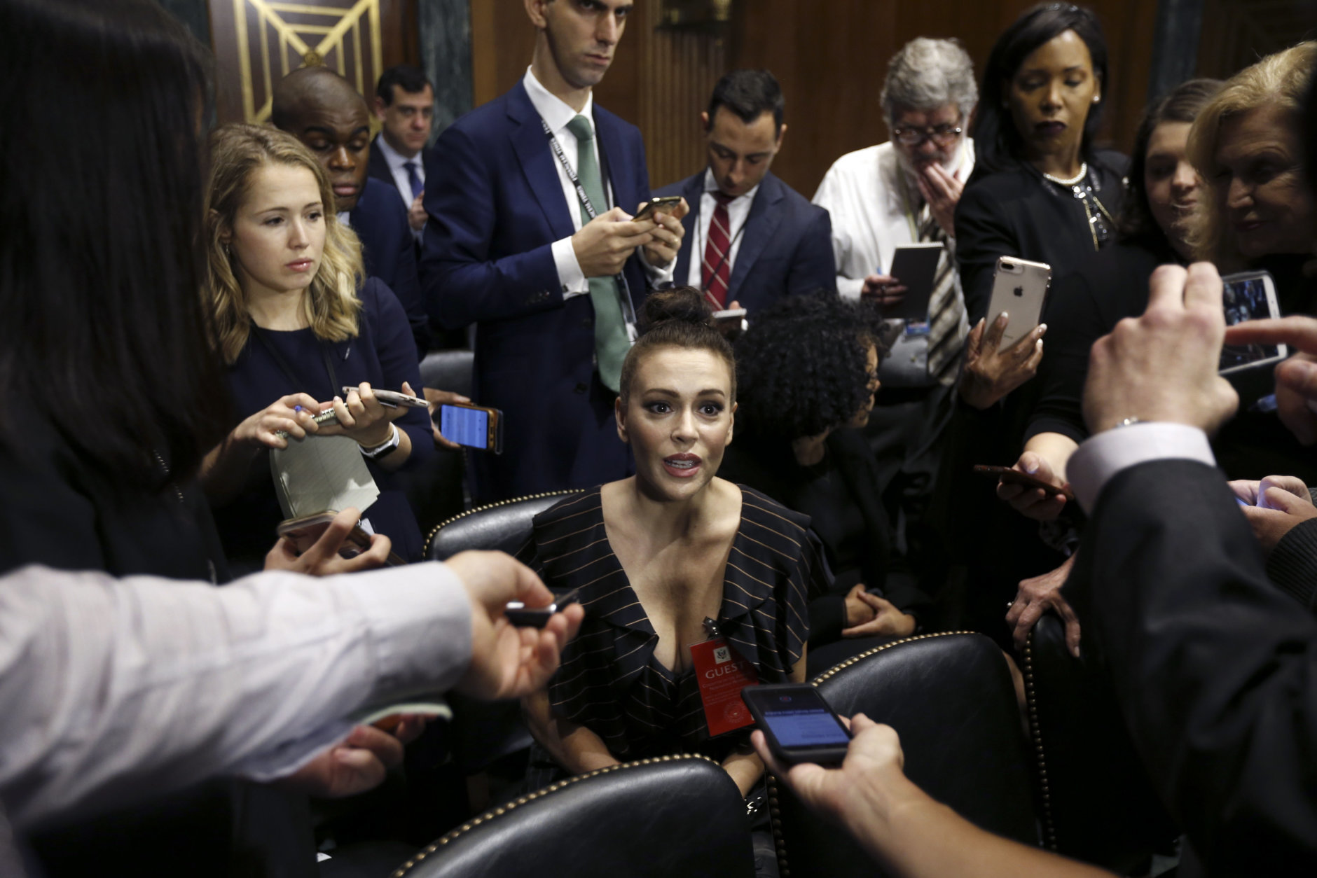 Actress Alyssa Milano talks to the media after she arrived for the Senate Judiciary hearing on Capitol Hill in Washington, Thursday, Sept. 27, 2018. with Christine Blasey Ford and Supreme Court nominee Brett Kavanaugh. (Michael Reynolds/Pool Photo via AP)