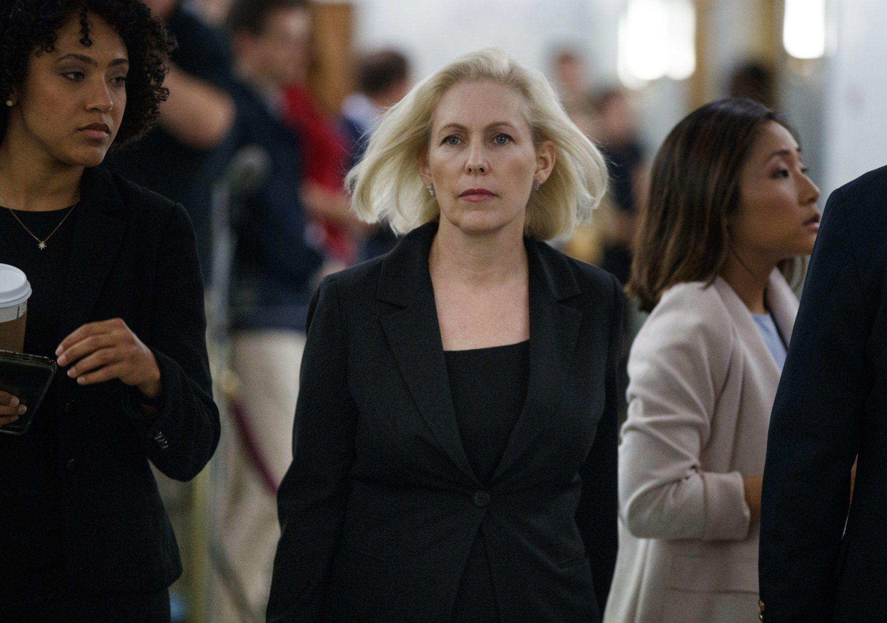 Sen. Kirsten Gillibrand, D-N.Y., walks outside the hearing room during a break in a Senate Judiciary Committee hearing on Capitol Hill in Washington, Thursday, Sept. 27, 2018, with Christine Blasey Ford and Supreme Court nominee Brett Kavanaugh. (AP Photo/Carolyn Kaster)
