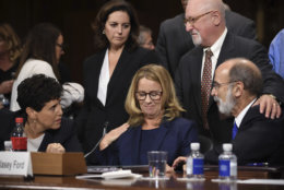 Christine Blasey Ford takes a break in her testimony before the Senate Judiciary Committee, Thursday, Sept. 27, 2018 on Capitol Hill in Washington. Lawyers seated are Debra Katz and Michael Bromwich. (Saul Loeb/ Pool Image via AP)