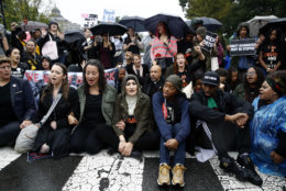 Protesters opposing Supreme Court nominee Brett Kavanaugh sit on a street between the Supreme Court and the U.S. Capitol on Capitol Hill in Washington, Thursday, Sept. 27, 2018. (AP Photo/Patrick Semansky)