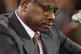 Judge Clarence Thomas pauses during testimony before the Senate Judiciary Committee on Capitol Hill in Washington, Oct. 12, 1991. Thomas flatly denied on Saturday that he had ever discussed pornographic movies with Anita Hill or anyone else in the workplace. (AP Photo/John Duricka)