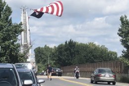People are waiting to say their final goodbyes to Sen. John McCain. The procession will pass under Church Road in Bowie, Maryland. (WTOP/Melissa Howell) 