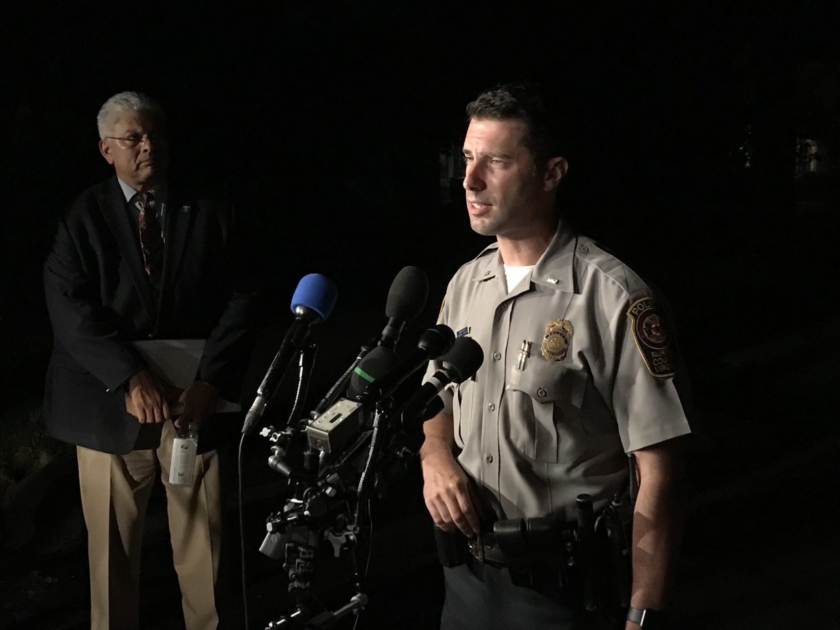 Lt. Eli Cory with Fairfax County police spoke with reporters on Wednesday, Sept. 5, 2018, near the scene where three people were found dead in Herndon, Virginia. (WTOP/Michelle Basch) 