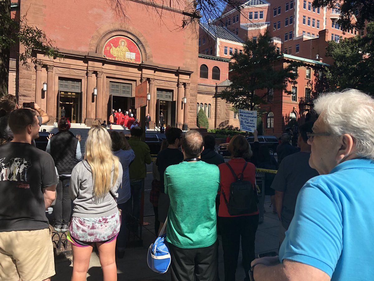 People were protesting outside the Red Mass at the Cathedral of St. Matthew the Apostle. (WTOP/Melissa Howell) 