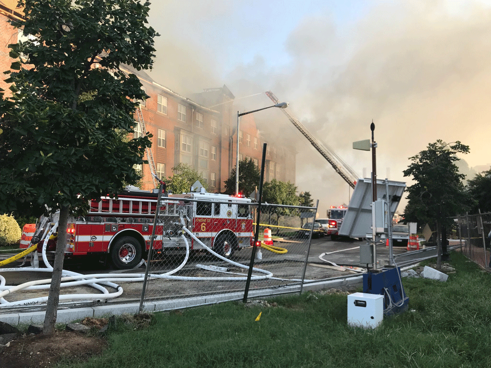 Firefighters pour water on a fire at the Arthur Capper Senior Public Housing building at 900 5th Street SE in D.C. (WTOP/Dick Uliano)