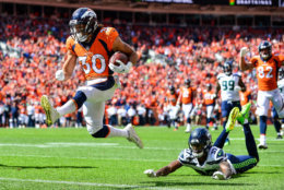DENVER, CO - SEPTEMBER 9:  Running back Phillip Lindsay #30 of the Denver Broncos scores a first quarter touchdown on a reception as cornerback Tre Flowers #37 of the Seattle Seahawks falls to the ground during a game at Broncos Stadium at Mile High on September 9, 2018 in Denver, Colorado. (Photo by Dustin Bradford/Getty Images)