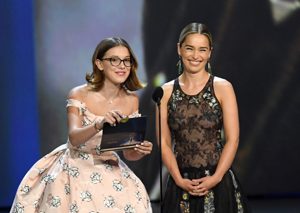 LOS ANGELES, CA - SEPTEMBER 17: Millie Bobby Brown (L) and Emilia Clarke speak onstage during the 70th Emmy Awards at Microsoft Theater on September 17, 2018 in Los Angeles, California. (Photo by Kevin Winter/Getty Images)