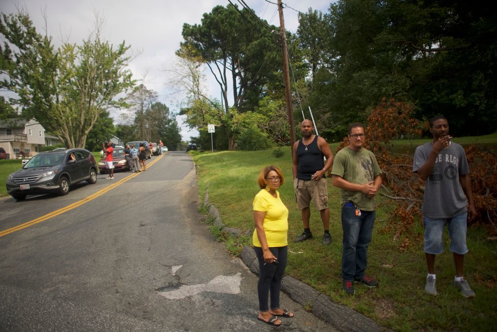 ABERDEEN, MD - SEPTEMBER 20:  Locals gather across the street from a barricade near the business park where multiple people were killed and injured in a shooting on September 20, 2018 in Aberdeen, Maryland. A woman opened fire at the distribution center killing three and wounding several others. The suspect, in critical condition, was taken into custody. (Photo by Mark Makela/Getty Images)