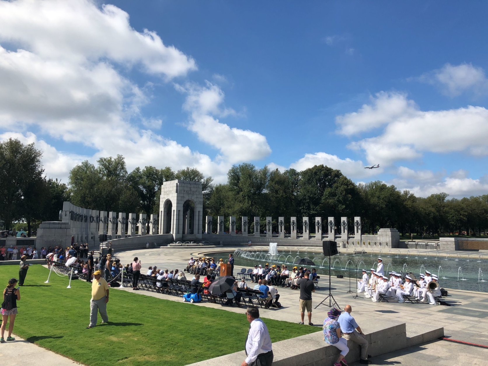 Dozens gathered to honor V-J Day at the World War II memorial. (WTOP/Keara Dowd)