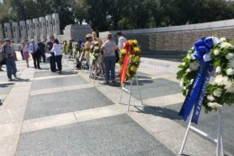 World War II veterans presented commemorative wreaths at the National World War II Memorial to honor the 73rd anniversary of V-J Day. (WTOP/Keara Dowd)