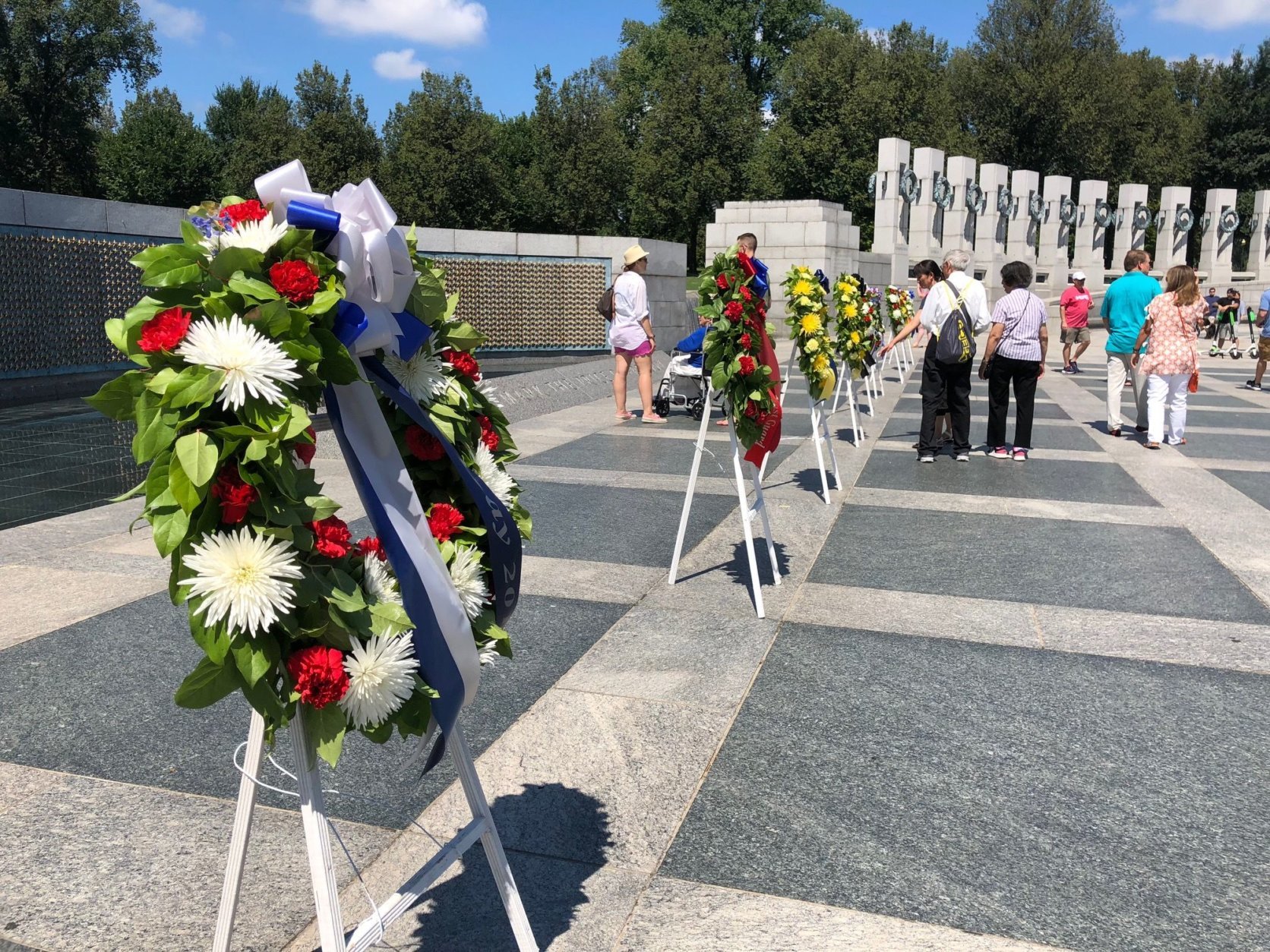 World War II veterans presented commemorative wreaths at the National World War II Memorial to honor the 73rd anniversary of V-J Day. (WTOP/Keara Dowd)