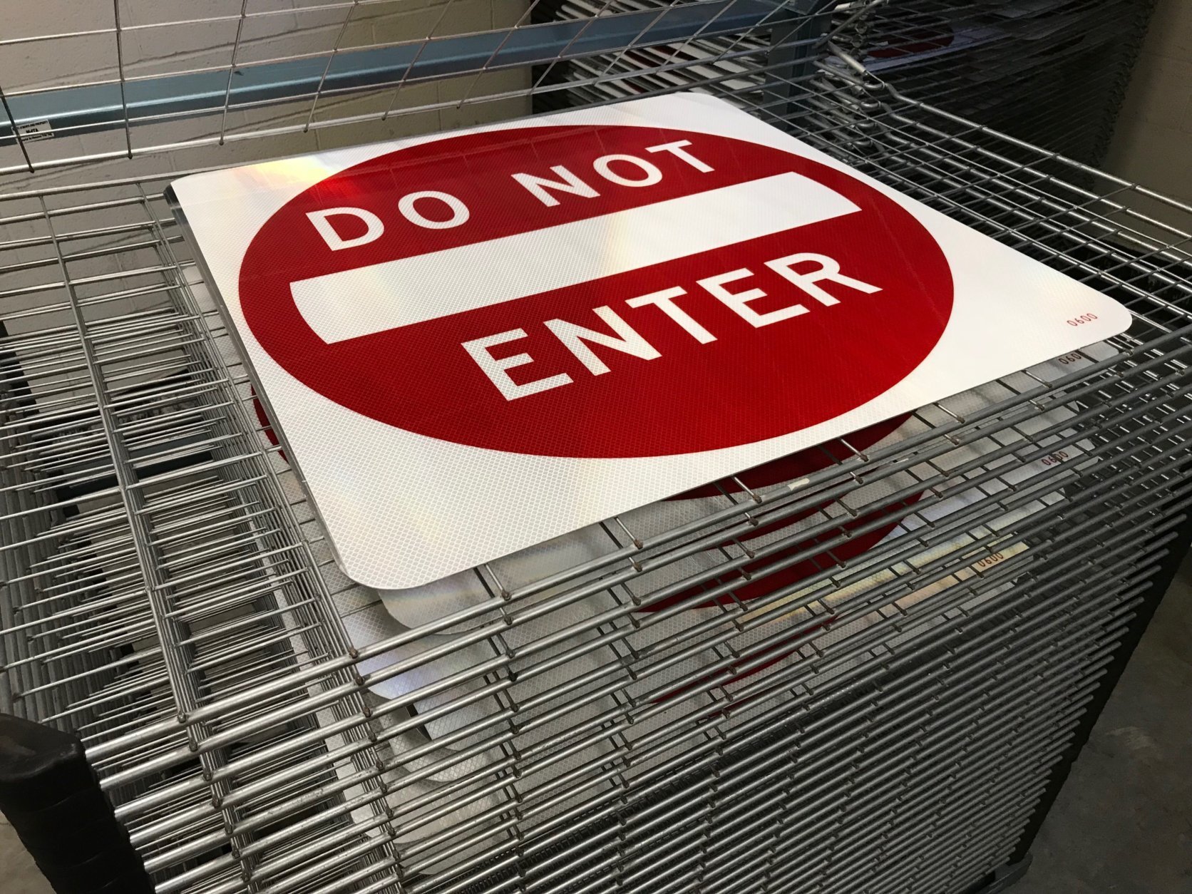Screen-printed signs are placed on a rack to dry. (WTOP/Michelle Basch)