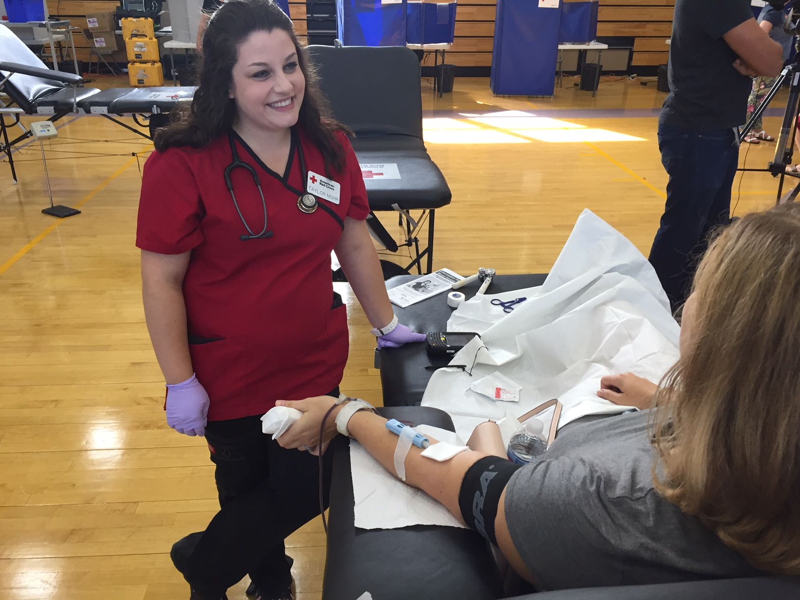 Claire Ward of Annapolis donates blood while Tracy Mohr of the red cross oversees. (WTOP/John Domen)