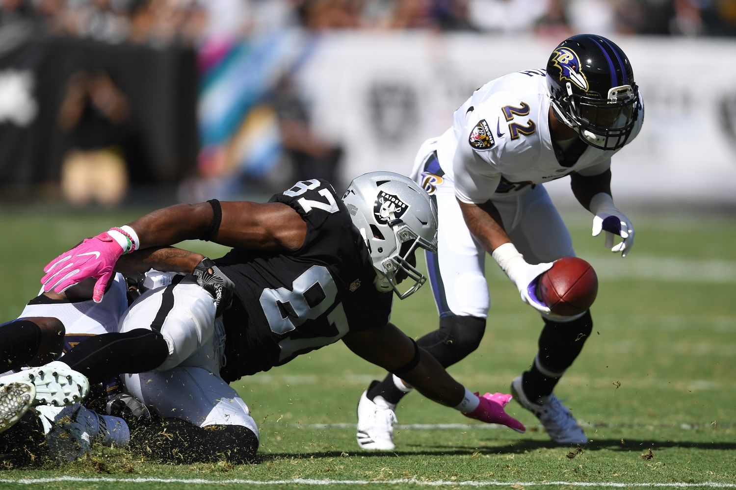 OAKLAND, CA - OCTOBER 08:  Jimmy Smith #22 of the Baltimore Ravens returns a recovered fumble by Jared Cook #87 of the Oakland Raiders for a touchdown during their NFL game at Oakland-Alameda County Coliseum on October 8, 2017 in Oakland, California.  (Photo by Thearon W. Henderson/Getty Images)