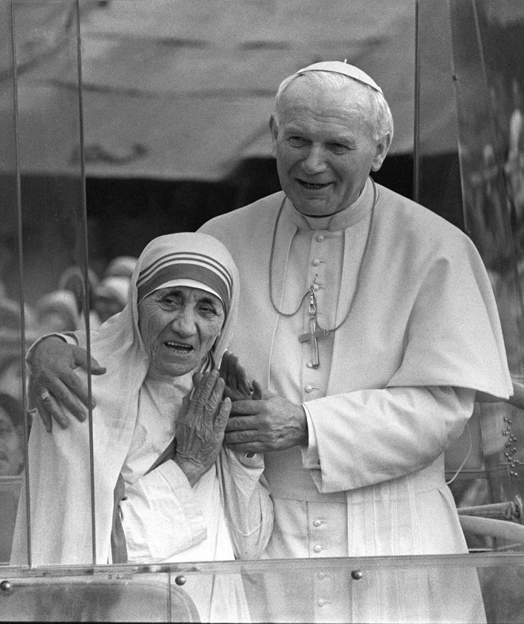 FILE--Pope John Paul II has his arms around Mother Teresa as they greet the faithful in the Popemobile Feb. 3, 1986, just outside the Home for the Dying in Calcutta, India. The Roman Catholic nun whose very name became synonymous with charity for her work with  the poorest of the poor,  has died. She was 87. (AP Photo)