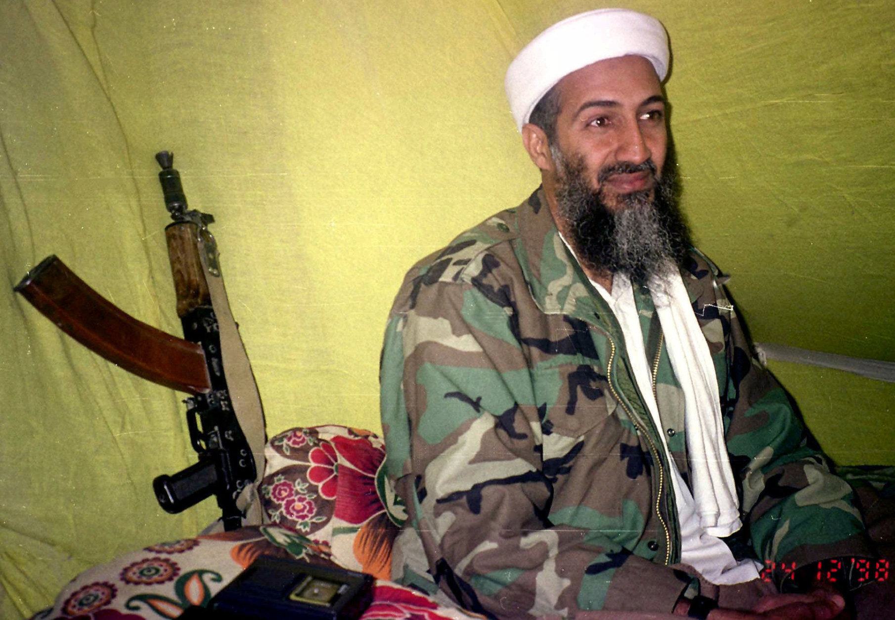 FILE - In this Dec. 24, 1998 file photo, Muslim militant and al-Qaida leader Osama Bin Laden speaks to a selected group of reporters in mountains of Helmand province in southern Afghanistan. The Americans who raided bin Laden's lair met far less resistance than the Obama administration described in the aftermath, according to its latest account. The commandos encountered gunshots from only one man, whom they quickly killed, before sweeping the house and shooting others, who were unarmed, a senior defense official said. (AP Photo/Rahimullah Yousafzai, File)
