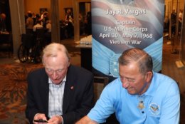 Congressional Medal of Honor recipient Jay Vargas autographs a book. (Courtesy Shmulik Almany/Congressional Medal of Honor Society)