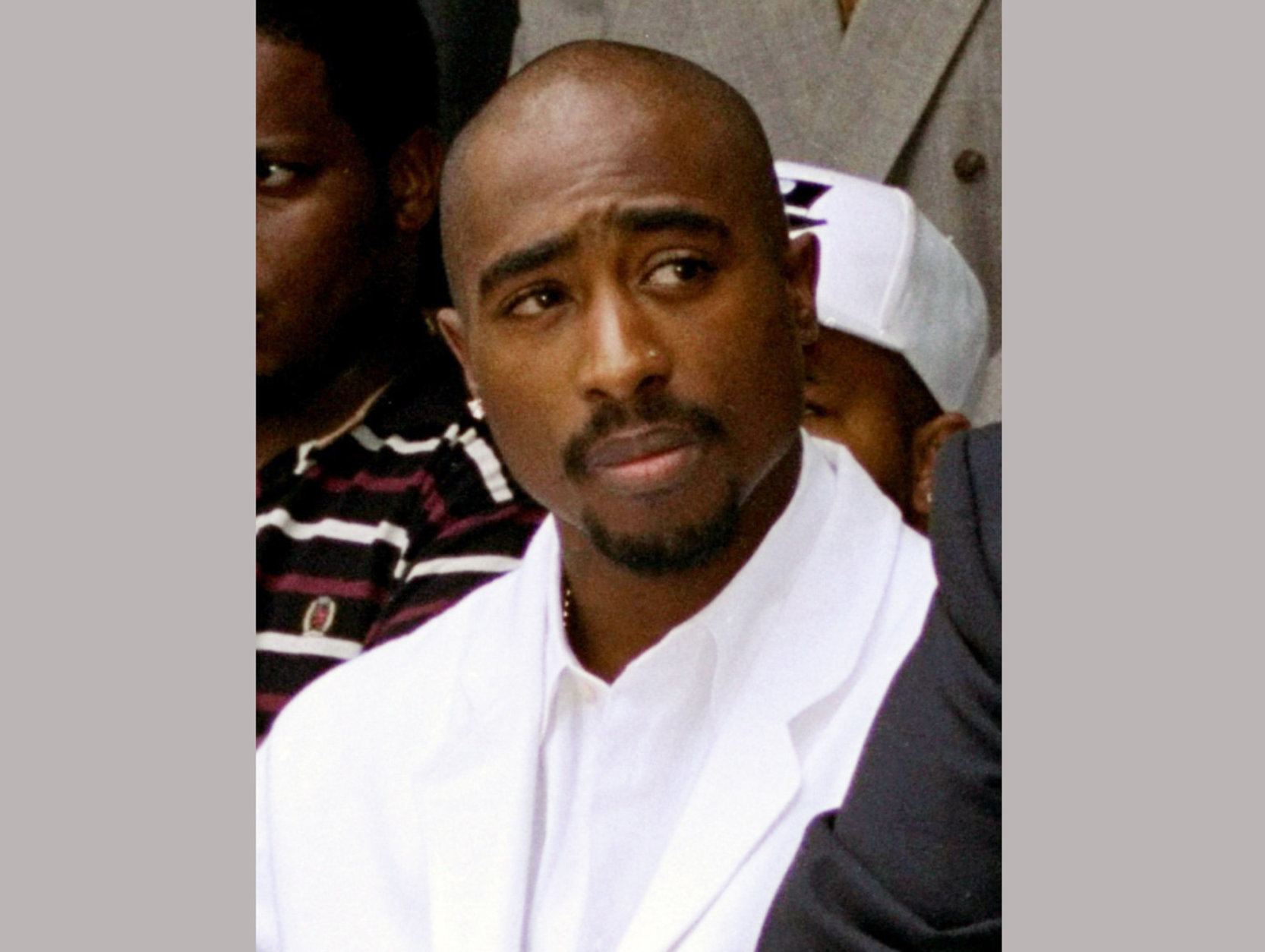 FILE - In this Aug. 15, 1996, file photo, rapper Tupac Shakur attends a voter registration event in South Central Los Angeles. Items owned by Shakur have been donated to Temple University, including a bullet-dented golden medallion the rapper was wearing in 1994 when he was shot five times. Diane Turner, the collection's curator, said Thursday, Nov. 1, 2018, that the Blockson Collection will increase its focus on hip-hop culture with the addition of Shakur's items. (AP Photo/Frank Wiese, File)