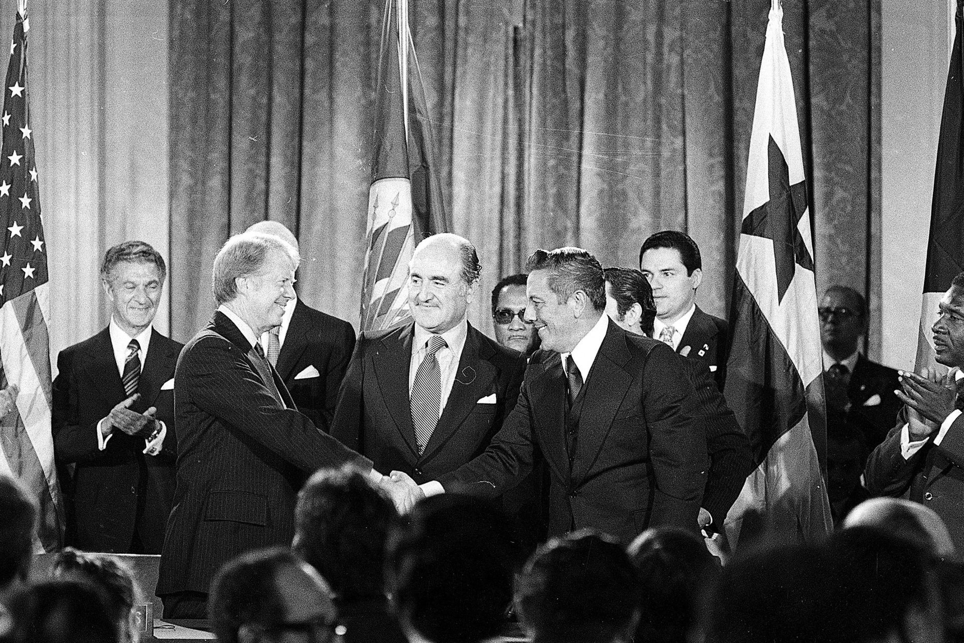 President Jimmy Carter shakes hands with Panama's head of government Omar Torrijos in Washington Sept. 7, 1977 after they signed the Panama Canal treaty.  Secretary General Alejandro Orfila stands at center.  (AP Photo)