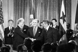 President Jimmy Carter shakes hands with Panama's head of government Omar Torrijos in Washington Sept. 7, 1977 after they signed the Panama Canal treaty.  Secretary General Alejandro Orfila stands at center.  (AP Photo)