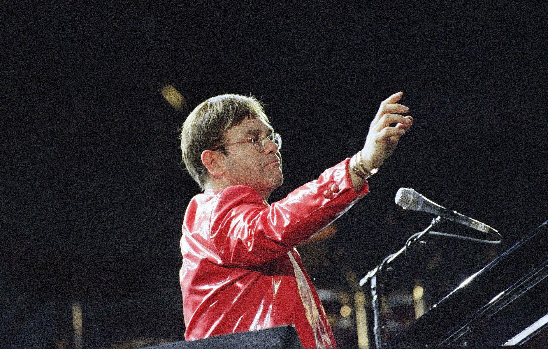 Elton John performs at the piano during a concert at Busch Stadium in St. Louis, Aug. 9, 1994. Elton John and Billy Joel performed together on stage for more than 50,000 fans. (AP Photo/James A. Finley)
