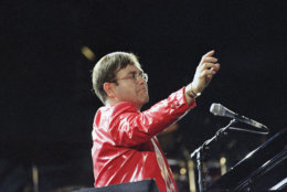 Elton John performs at the piano during a concert at Busch Stadium in St. Louis, Aug. 9, 1994. Elton John and Billy Joel performed together on stage for more than 50,000 fans. (AP Photo/James A. Finley)