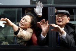 South Korean visitors in a bus wave to their North Korean relatives before they return to South Korea after the 13th Separated Family Reunion Meeting at Diamond Mountain in North Korea, Wednesday, March 22, 2006. About 150 South Koreans began a three-day reunion program at North Korea's Diamond Mountain resort on Monday, meeting with their North Korean relatives for the first time in more than half a century.(AP Photo/Munhwa Ilbo, Lim Jung-jyun, Korea Pool)  **KOREA OUT**