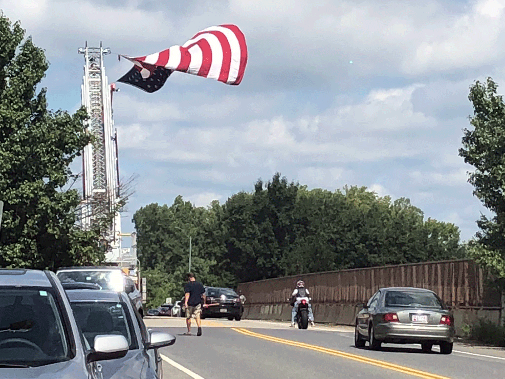 People wait to say their final goodbyes to Senator John McCain along Church Road above US 50 in Bowie, Maryland.  (WTOP/Melissa Howell)