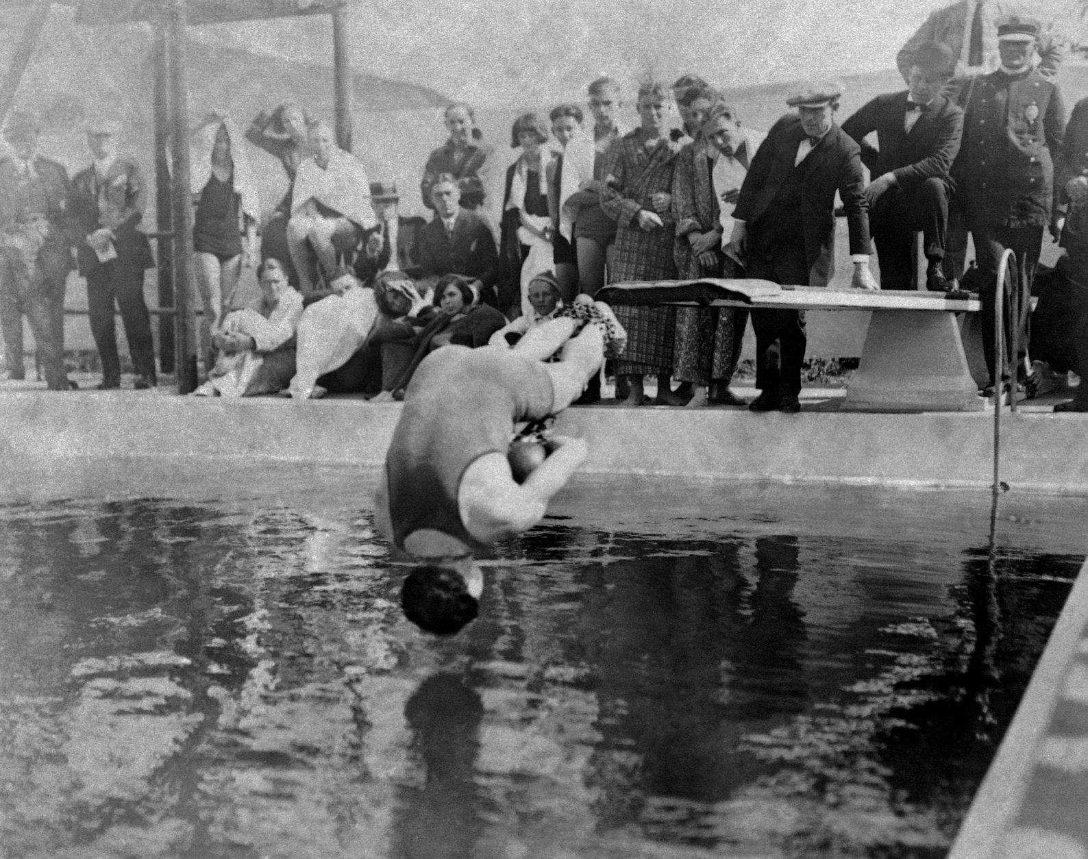 Harry Houdini, handcuffed, and with his feet bound in chains, dives into pool at Los Angeles, May 7, 1923. (AP Photo)