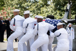 Navy Body Bearers move the casket of the late Sen. John McCain from his processional hearse to the United States Naval Academy Chapel, Sept. 2, 2018. John Sidney McCain, III graduated from the United States Naval Academy in 1958. He was a pilot in the United States Navy from 1958 until 1981. From 1967 to 1973 he was a prisoner of war in Vietnam. He received numerous awards, including the Silver Star, Legion of Merit, Purple Heart, and Distinguished Flying Cross. U.S. Navy photo by Mass Communication Specialist 2nd Class Nathan Burke. (Courtesy U.S. Naval Academy Public Affairs)