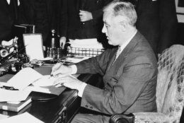 President Franklin Roosevelt is shown signing the neutrality bill in the White House, Washington on Nov. 4, 1939 making  law this bill which opens American markets to belligerent cash-and-carry purchasers.   The chief executive signed the bill before a gathering of congressional leaders and cabinet members - including Cordell Hull, Secretary of State. Only Roosevelt is shown in image. (AP Photo)