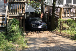 Outside a Glover Park home, the car that pinned a man who died still sits at the scene of the apparent accident. (WTOP/Kristi King)