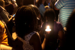 Neighbors lit candles and released balloons during a vigil, Thursday, Sept. 13, 2018, for slain teenager TaQuan Pinkney. (WTOP/Mike Murillo)