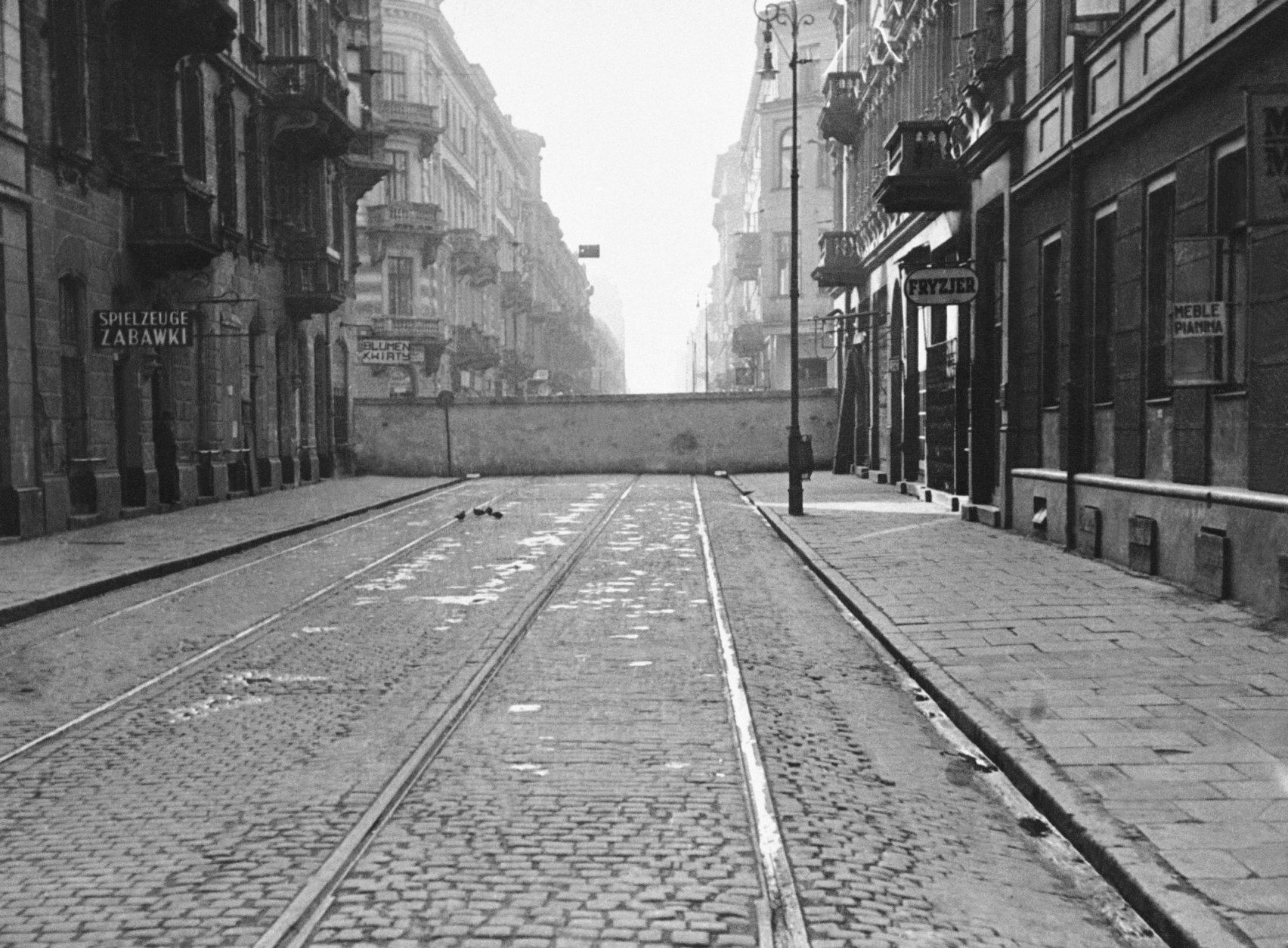 A wall of the Warsaw Ghetto cuts across a street in central Warsaw, Poland, on Dec. 20, 1940. The ghetto, built by the Nazis in 1940 as a pen for Warsaw's approximately 500,000 Jews, was enclosed by red brick and grey stone walls more than 10 feet high, topped with barbed wire, and enclosing an area of about 1.3 square miles (3.4 square km), roughly the size New York's Central Park. (AP Photo/Alvin Steinkopf)