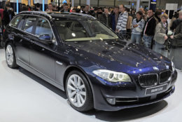 Visitors stand besides the new BMW 5 Series Touring during the World presentation at the AMI Leipzig Car Fair 2010 in Leipzig, Germany, Saturday, April 10, 2010. As the only international car show being held in Germany in 2010, AMI is one of the leading European get-togethers for the motor vehicle industry. The organisers expect over 500 exhibitors at the 20th edition of the Auto Mobil International (AMI). The AMI opens its doors to the public April 10 through April 18. (AP Photo/Jens Meyer)