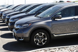 In this Thursday, Aug. 30, 2018, photograph, a long line of unsold 2018 CR-V sports utility vehicles sits at a Honda dealership in Highlands Ranch, Colo. (AP Photo/David Zalubowski)