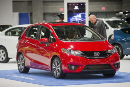 People look over a 2015 Honda Fit vehicle on display at the Washington Auto Show, Friday, Jan. 30, 2015, in Washington. (AP Photo/Pablo Martinez Monsivais )