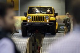 Media enjoy a free ride with a 2014 Jeep Wrangler Unlimited Rubicon edition during the media preview of the Chicago Auto Show at McCormick Place in Chicago on Friday, Feb. 7, 2014. Chicago Auto Show will be open to the public February 8 through February 17. (AP photo/Nam Y. Huh)