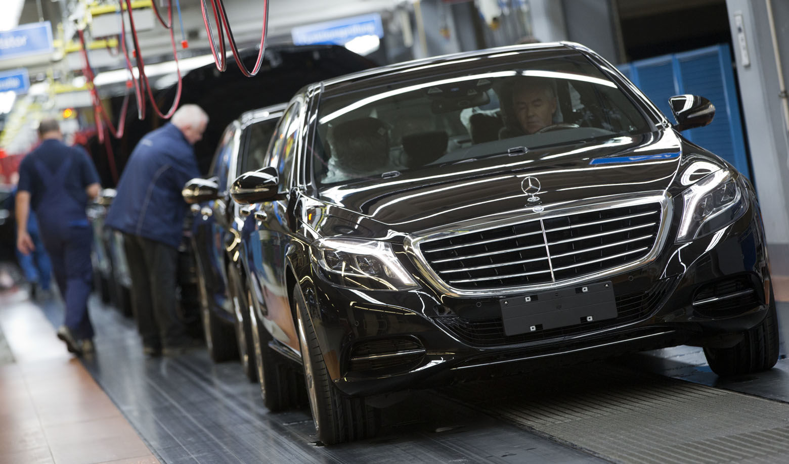 In this Jan. 28, 2015 picture an employee of the Mercedes-Benz AG checks a S-Class model at the plant in Sindelfingen, Germany. Daimler will present its second quarter earning Thursday, July 23, 2015.  (AP Photo/Matthias Schrader)