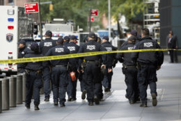 NYPD officers depart from the Time Warner Center area on Wednesday, Oct. 24, 2018, in New York.  A police bomb squad was sent to CNN's offices in New York City and the newsroom was evacuated because of a suspicious package. (AP Photo/Kevin Hagen)