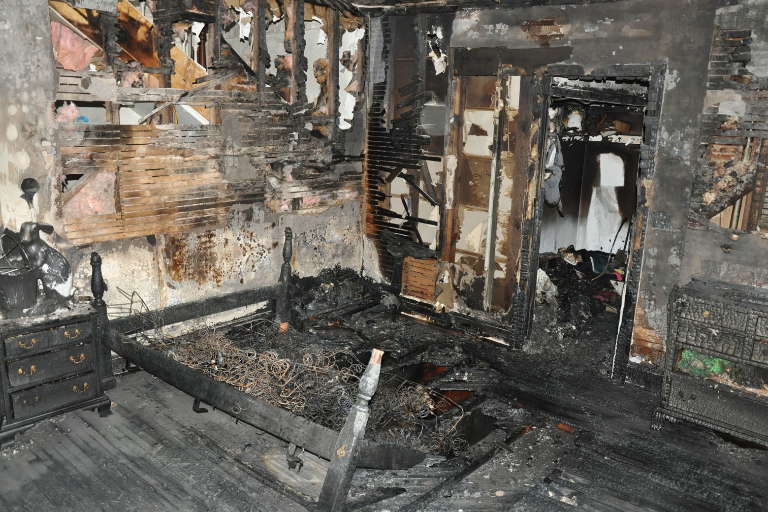 The burned-out upstairs bedroom where the body of 10-year-old Philip Savopoulos was found. The fire burned so hot, it burned through the floorboards. Fire investigators told the jury the fire started on the bed. (Courtesy U.S. Attorney's Office for D.C.)