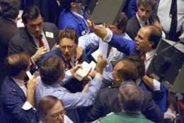 FILE - In this Oct. 19, 1987, file photo, traders work on the floor of the New York Stock Exchange. What if the stock market plunged 20 percent tomorrow? The question may seem absurd when the market is in the midst of one of its calmest runs in history and at record highs. But it's what investors had to deal with 30 years ago, when "Black Monday" blasted stocks on Oct. 19, 1987. (AP Photo/Peter Morgan, File)