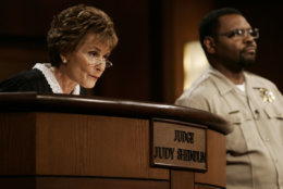 FILE - In this Feb. 2, 2006, file photo, Judge Judy Sheindlin presides over a case as her bailiff Petri Hawkins Byrd listens on the set of her syndicated show "Judge Judy" at the Tribune Studios in Los Angeles. Sheindlin, better known as Judge Judy, is funding a space for public debate at the University of Southern California. The forum, which was to be unveiled Tuesday night, Sept. 12, 2017, will host the USC Annenberg Debate Series. (AP Photo/Damian Dovarganes, File)