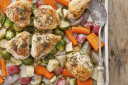 This undated photo provided by America's Test Kitchen in May 2018 shows one-pan roasted chicken with root vegetables in Brookline, Mass. This recipe appears in the cookbook “How to Roast Everything.” (Joe Keller/America's Test Kitchen via AP)