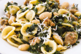 This undated photo provided by America's Test Kitchen in September 2018 shows pasta with sausage, kale and white beans in Brookline, Mass. This recipe appears in the cookbook “One-Pan Wonders.” (Joe Keller/America's Test Kitchen via AP)