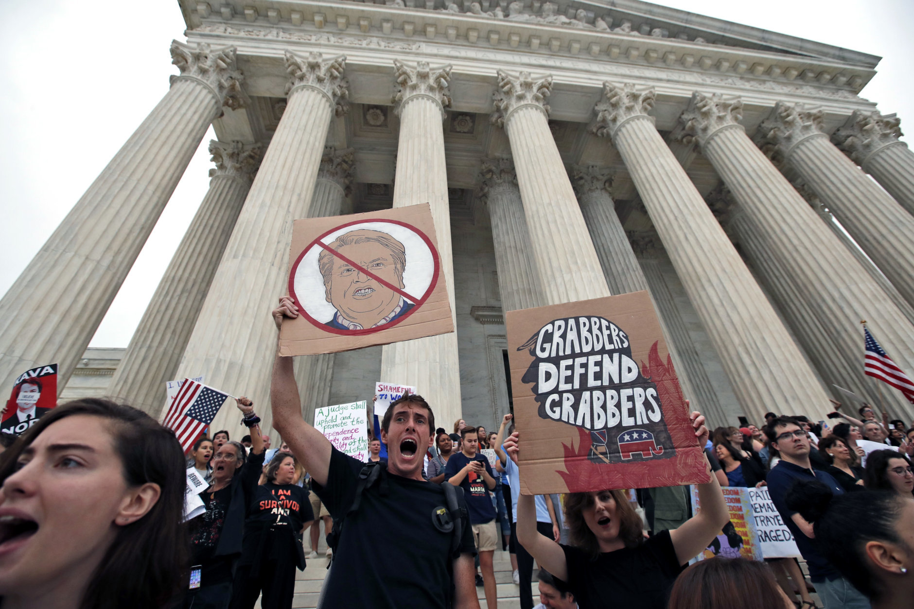 People protest on the steps of the Supreme Court after the confirmation vote of Supreme Court nominee Brett Kavanaugh, on Capitol Hill, Saturday, Oct. 6, 2018 in Washington. (AP Photo/Alex Brandon)