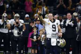 New Orleans Saints quarterback Drew Brees (9) responds to the crowd after breaking the NFL all-time passing yards record in the first half of an NFL football game against the Washington Redskins in New Orleans, Monday, Oct. 8, 2018. (AP Photo/Butch Dill)