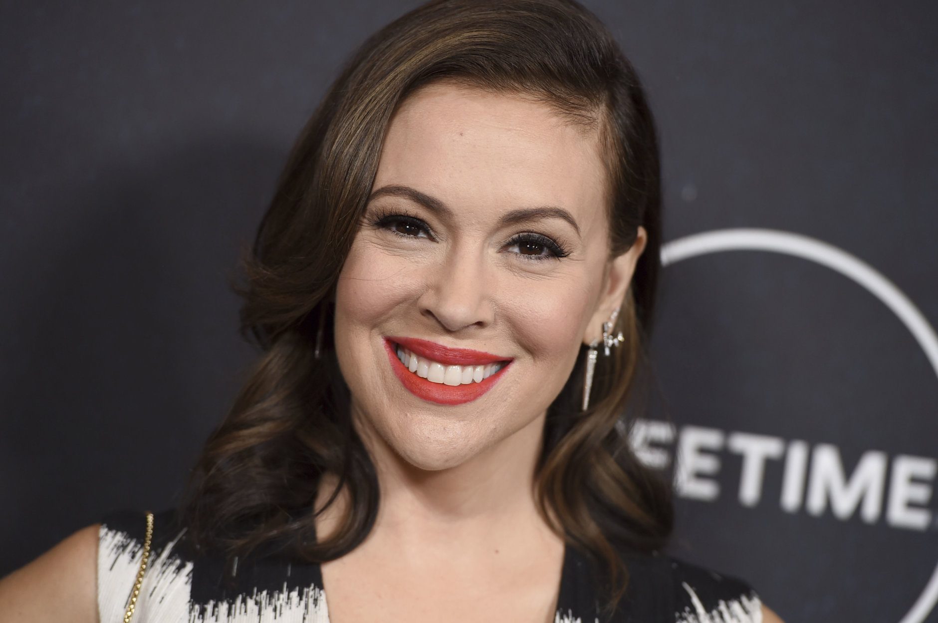 FILE - In this Oct. 12, 2018, file photo, Alyssa Milano arrives at Variety's Power of Women event at the Beverly Wilshire hotel in Beverly Hills, Calif. On Oct. 15, 2017, Milano urged the Twittersphere to join her in sharing a personal story of sexual harassment in the wake of rape allegations against Harvey Weinstein. The response was immediate and overwhelming, and touched off a cultural movement that has shed light on the pervasiveness of sexual harassment, assault and violence against women across all industries, building on work started over a decade earlier by activist Tarana Burke. (Photo by Jordan Strauss/Invision/AP, File)
