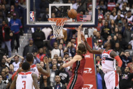 Miami Heat forward Kelly Olynyk, second from right, puts up a shot against Washington Wizards forward Jeff Green (32) during the closing seconds of the second half of an NBA basketball game, Thursday, Oct. 18, 2018, in Washington. Also seen are Wizards guard Bradley Beal (3) and forward Markieff Morris, second from left. The Heat won 113-112. (AP Photo/Nick Wass)